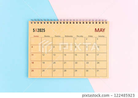 May 2025 craft brown paper calendar on pink and blue background. May 2025 craft brown paper calendar on pink and blue background. 122485923