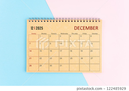 December 2025 craft brown paper calendar on pink and blue background. December 2025 craft brown paper calendar on pink and blue background. 122485929