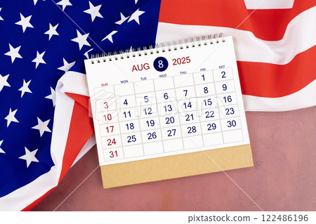 August 2025 Monthly desk calendar and United States of America flag. 122486196