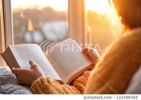 Cozy Sunday Morning with a Person Reading a Book Cozy Sunday Morning with a Person Reading a Book 122486568