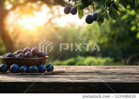 A bowl of blue plums sits on a wooden table 122486616