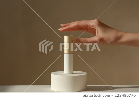 A hand is holding a small bottle of makeup A hand is holding a small bottle of makeup 122486770