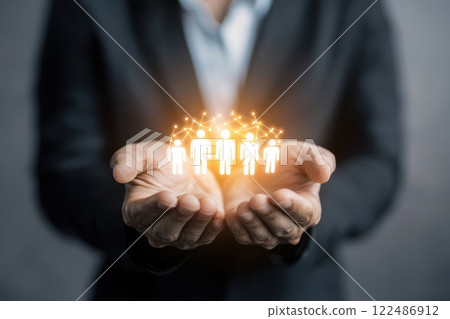 Hands Holding Iconic Representation of People Connected in a Network with Glowing Effect Hands Holding Iconic Representation of People Connected in a Network with Glowing Effect 122486912