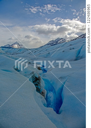 Deep crevasse on Grey Glacier in Patagonia showcasing vibrant blue ice 122486965