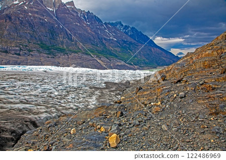 Surface of Grey Glacier with crevasses and surrounding dramatic mountains in Torres del Paine National Park Surface of Grey Glacier with crevasses and surrounding dramatic mountains in Torres del Paine National Park 122486969
