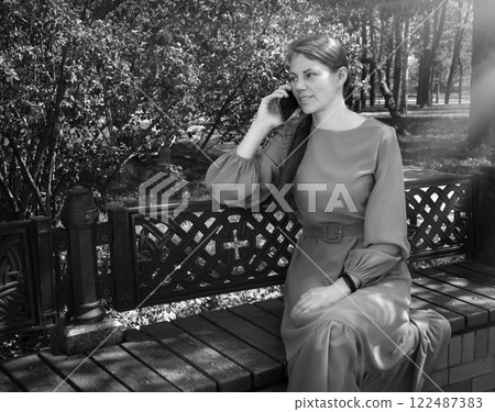 Pretty girl sitting on the bench Pretty girl sitting on the bench 122487383