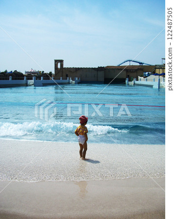 Toddlers playing on the beach 122487505