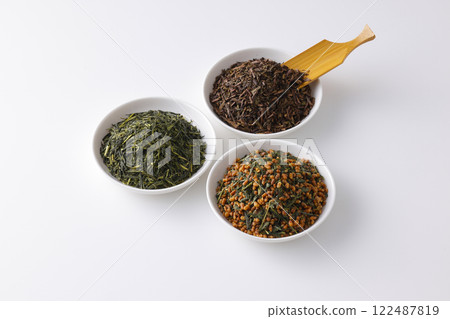 Green tea, roasted green tea and brown rice tea leaves on a plate Green tea, roasted green tea and brown rice tea leaves on a plate 122487819