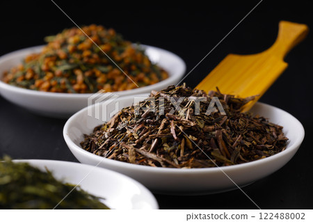 Green tea, roasted green tea and brown rice tea leaves on a plate 122488002