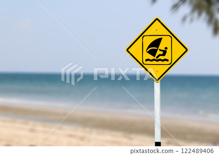 A clear yellow sign featuring a windsurfer symbol, designating an area for windsurfing activities, guiding sports enthusiasts to safe and approved zones. 122489406