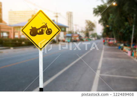 A bold yellow sign marking designated motorcycle parking spaces along the roadside, helping maintain organized and efficient parking for riders. 122489408