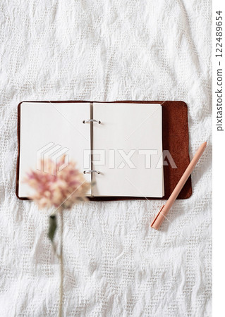 Open journal on the blanket. Open journal on the blanket. 122489654