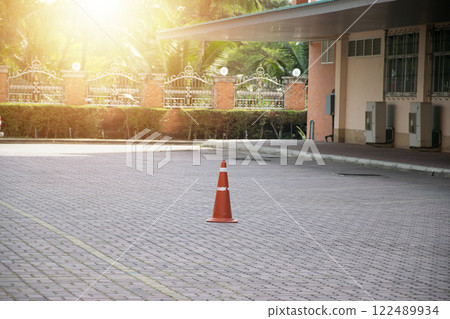 Red and white traffic cones placed on the ground 122489934