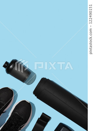 Black workout equipment for training at home on blue background. Fitness, sport items, healthy lifestyle concept. Copyspace Black workout equipment for training at home on blue background. Fitness, sport items, healthy lifestyle concept. Copyspace 122490151