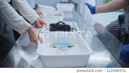 Diverse People Put Personal Items in Plastic Trays for Screening. Security Officers Control Procedures 122490331