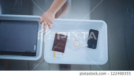 Top View on Diverse People Putting Personal Belongings in Plastic Trays for Screening Top View on Diverse People Putting Personal Belongings in Plastic Trays for Screening 122490355