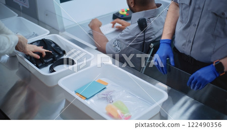 Boarding Flight: Diverse Passengers Put Personal Belongings in Plastic Trays for Screening Boarding Flight: Diverse Passengers Put Personal Belongings in Plastic Trays for Screening 122490356