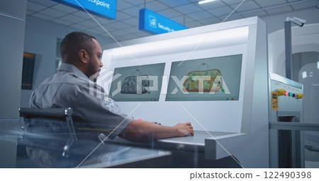 Security Officer Controls Luggage Screening on Computer Monitors Using Modern Software 122490398