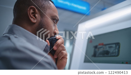 Airport Terminal: Security Officer Monitors X-ray Luggage Scanning on Screens, Finds Suspicious Item Airport Terminal: Security Officer Monitors X-ray Luggage Scanning on Screens, Finds Suspicious Item 122490413
