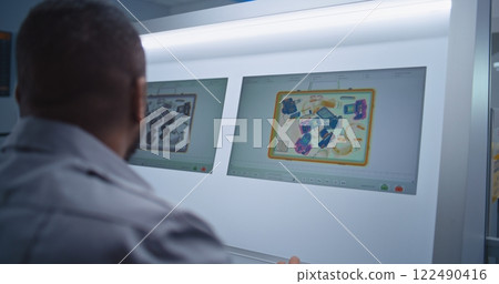 Back View of Security Officer Monitoring Baggage Screening on Computer Back View of Security Officer Monitoring Baggage Screening on Computer 122490416