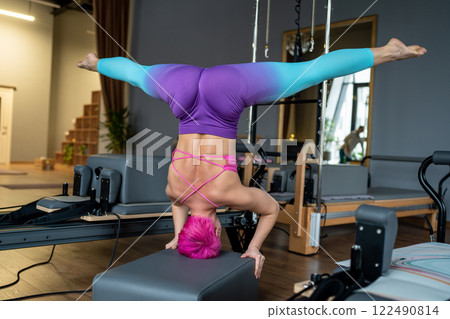 Engaging in Dynamic Aerial Fitness Training while wearing Colorful and EyeCatching Attire 122490814