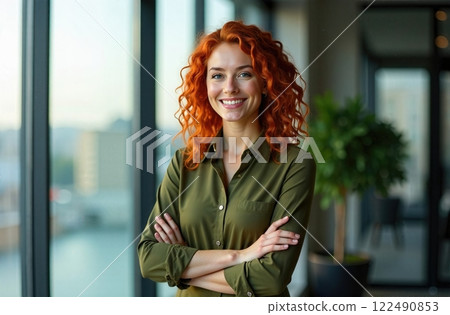 A Smiling Redhead Posing Cheerfully in a Stylish and Modern Office Space Setting 122490853