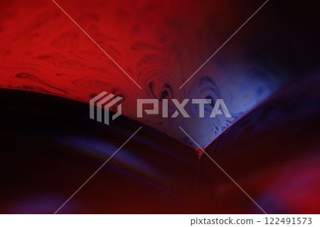Red reflections of liquid in macro, bubbles in macro, connection of bubbles in macro, cell from liquid, horror background, glossy panels, red on black 122491573