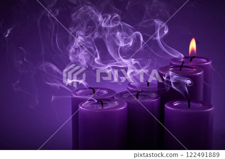 Purple Serenity. Six purple candles emit graceful smoke, creating a tranquil atmosphere. Purple Serenity. Six purple candles emit graceful smoke, creating a tranquil atmosphere. 122491889