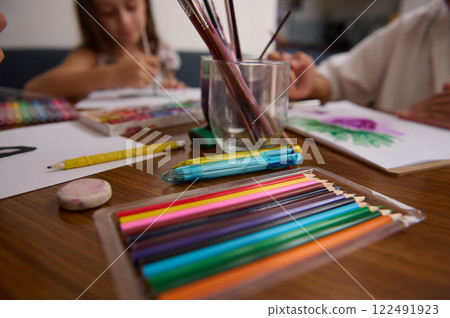 Children Engaged in Arts and Crafts With Colorful Supplies and Pencils 122491923