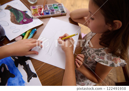 Young girl engaging in creative drawing and artwork at home Young girl engaging in creative drawing and artwork at home 122491938
