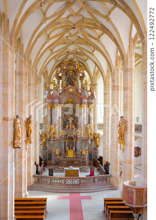 The interior of the Church of the Assumption of the Virgin Mary in Most showcases stunning late Gothic architecture, featuring detailed altarpieces, statues, and a serene ambiance for visitors. 122492772