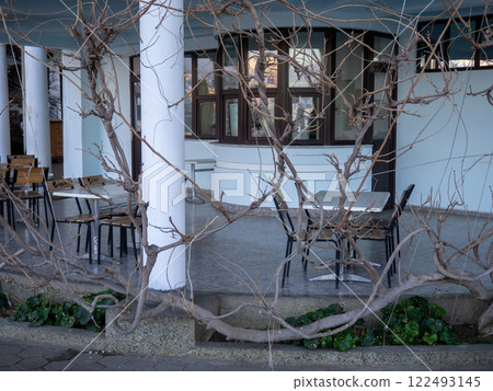 Restaurant veranda in winter. Empty tables in a cafe. Winter at the summer resort. Business under threat 122493145