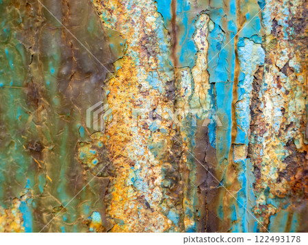 Rust on a blue surface. Cracks in the paint. Old iron. Rusty metal. 122493178