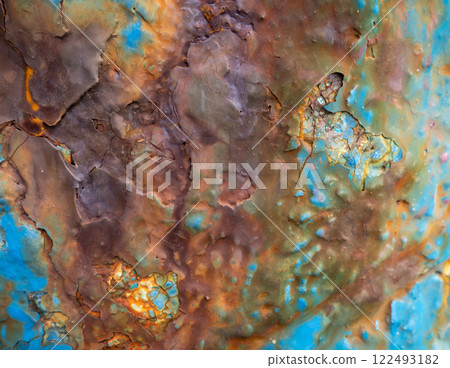Rust on a blue surface. Cracks in the paint. Old iron. Rusty metal. 122493182