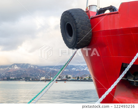 nose of the ship is red. Tire on the bow of the ship. Safety . Moored ship. nose of the ship is red. Tire on the bow of the ship. Safety . Moored ship. 122493216