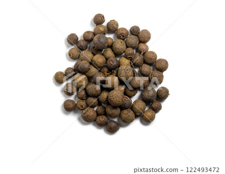 Allspice on a white background. Peppercorn isolate. Seasoning for dishes. Cooking. Allspice on a white background. Peppercorn isolate. Seasoning for dishes. Cooking. 122493472