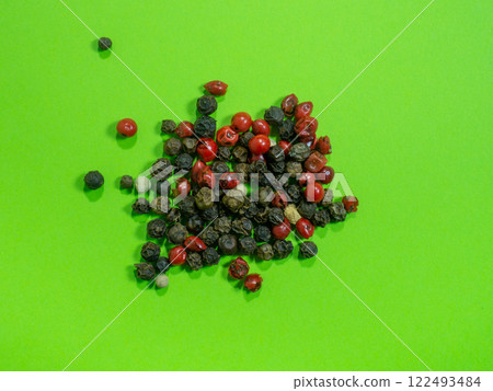 Peppercorns on a green background. Red, white and black peppercorns. concept of natural cuisine. Seasoning for dishes. The concept of spicy food. Spicy condiment. Cooking. Peppercorns on a green background. Red, white and black peppercorns. concept of natural cuisine. Seasoning for dishes. The concept of spicy food. Spicy condiment. Cooking. 122493484