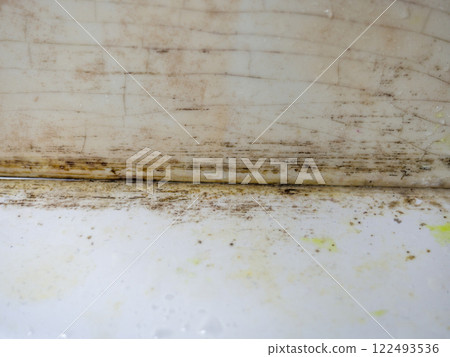 Mold in the bathroom. Black dots of mold and yellow plaque. Black mold Dirt on tiles. Requires cleaning 122493536