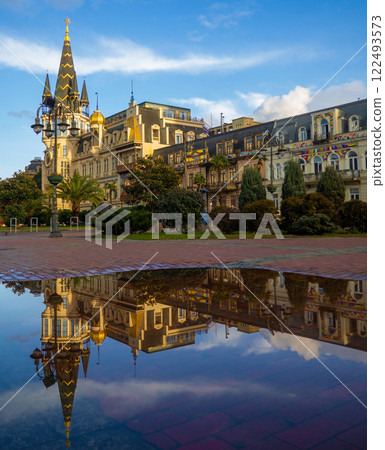 Landmark of Batumi in the reflection of a puddle. Europe Square. Architecture of Georgia. City Park. Landmark of Batumi in the reflection of a puddle. Europe Square. Architecture of Georgia. City Park. 122493573