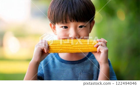 Boy biting into corn 122494046