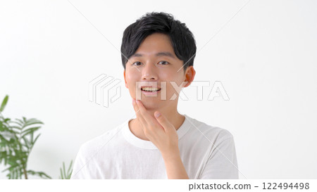 Man shaving with an electric shaver 122494498