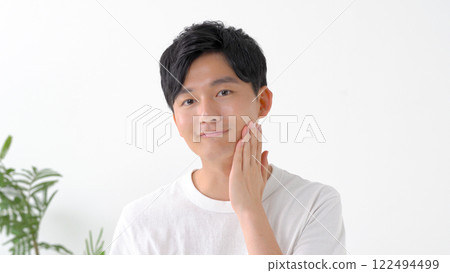 Man shaving with an electric shaver 122494499