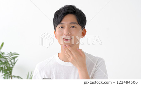 Man shaving with an electric shaver 122494500