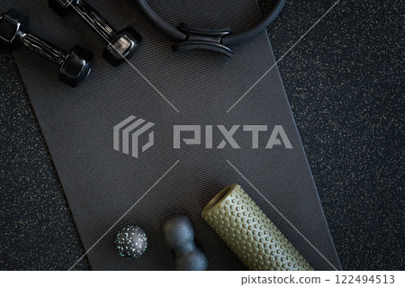 Sports massagers manual and electric in the gym on a mat of black color. Sports massagers manual and electric in the gym on a mat of black color. 122494513