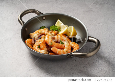 Cooked red prawn with spices in a pan, served with fresh herbs and lemon Cooked red prawn with spices in a pan, served with fresh herbs and lemon 122494728