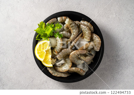 Raw Shrimps prawns and ice cubes with lemons Raw Shrimps prawns and ice cubes with lemons 122494733