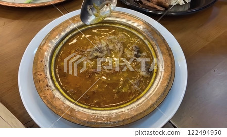 Traditional Turkish Kelle Paca Soup Presented in an Ornate Copper Bowl Traditional Turkish Kelle Paca Soup Presented in an Ornate Copper Bowl 122494950