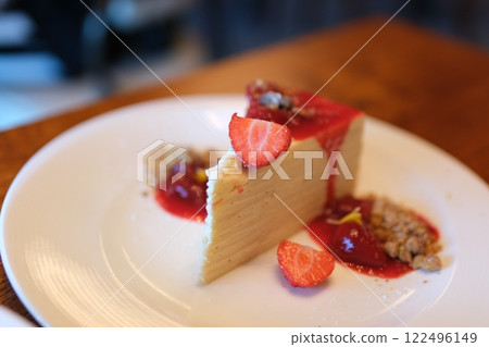 white cake with strawberry jam Close-up of a female chef stirring strawberry jam in a saucepan with a silicone spatula in a professional kitchen. 122496149