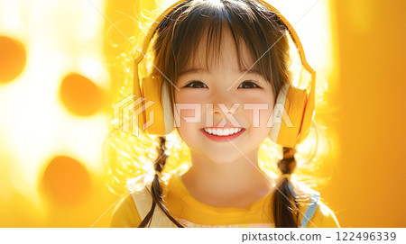 Cute smiling girl with yellow headphones 122496339
