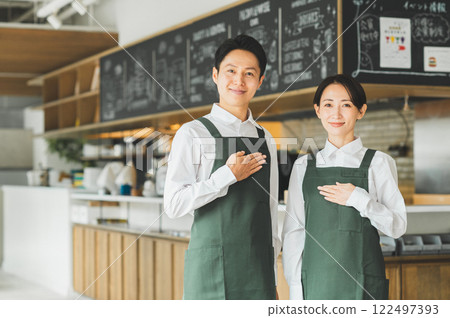 Middle-aged men and women working in a cafe Middle-aged men and women working in a cafe 122497393